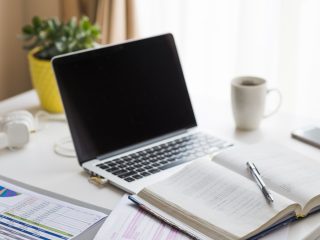 notebook-near-laptop-table