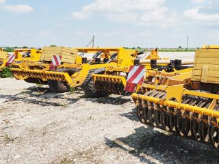 close-up-seeder-attached-tractor-field-low